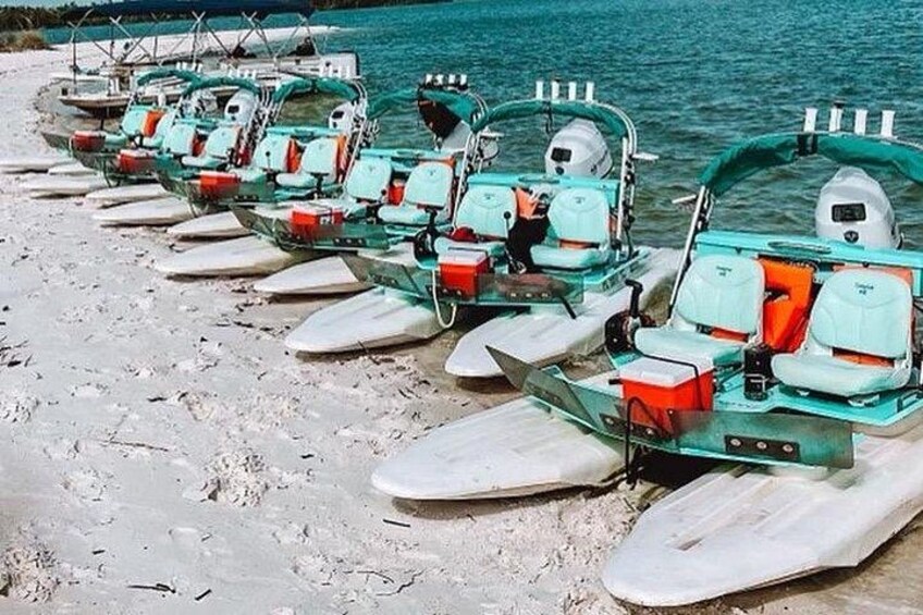 A row of amphibious vehicles parked on a sandy beach. 5
