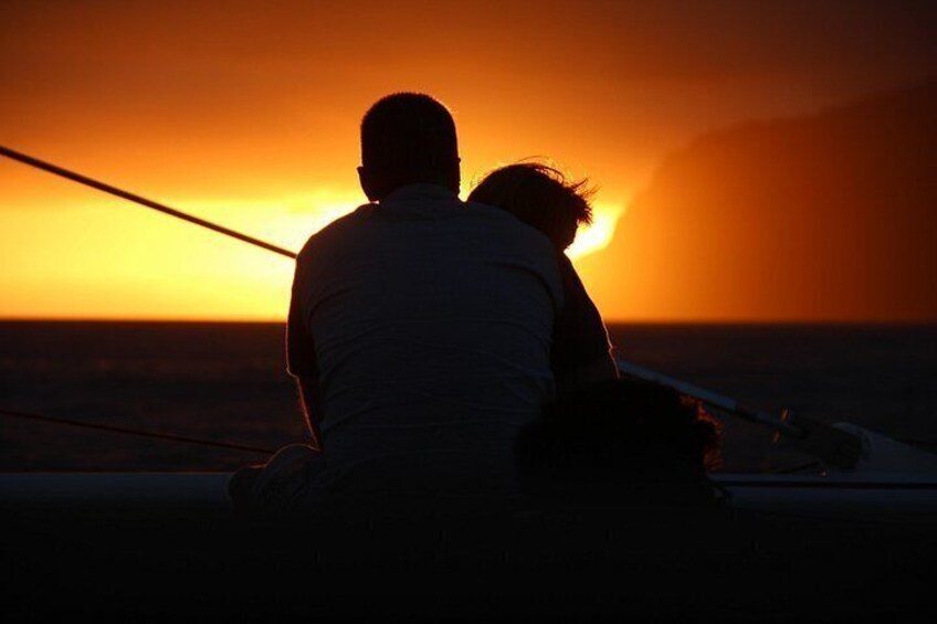 A person sitting on a boat during sunset. 2