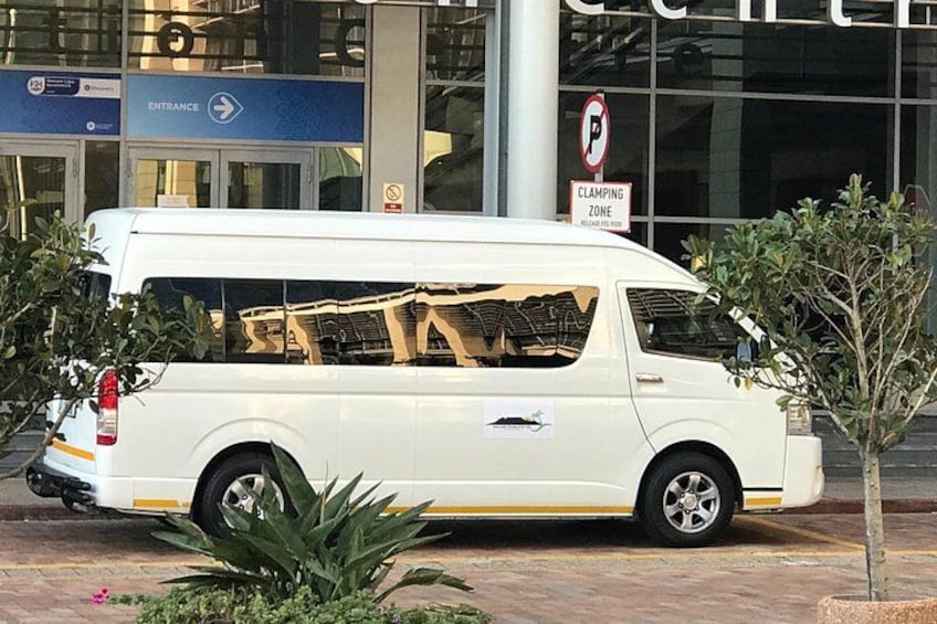 A white van parked in front of a building with a sign indicating a no parking zone and a clamping zone. 3