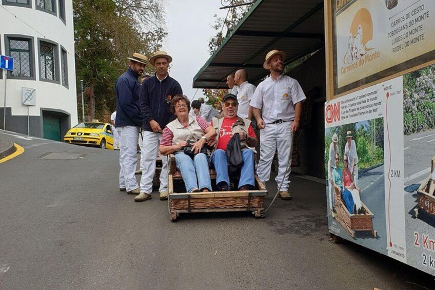 A group of people in a cart, a yellow taxi, and a signboard with text. 4