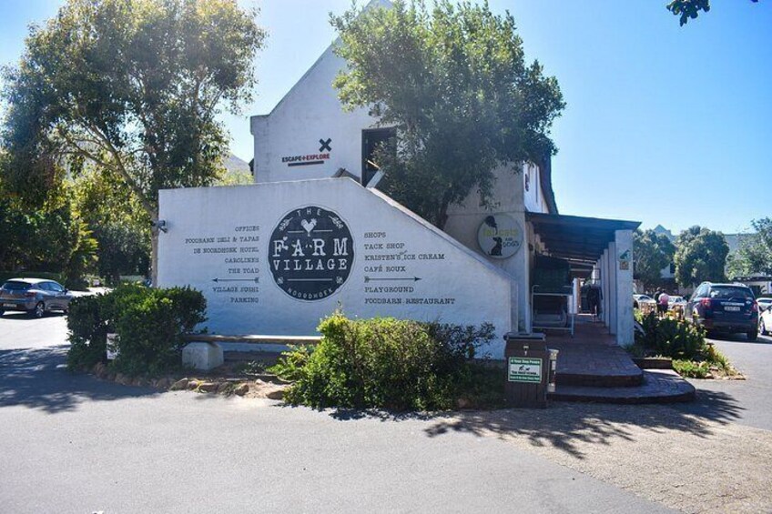 A sign for Farm Village with a list of amenities including a hotel, ice cream shop, and restaurant. 3