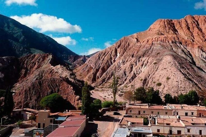 A mountainous landscape with a small settlement nestled among the hills. 5