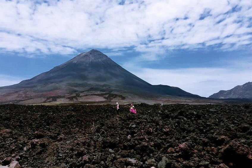 A volcanic landscape with a prominent mountain in the background. 3
