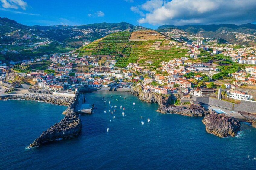 A coastal town with a harbor, boats, and buildings. 2
