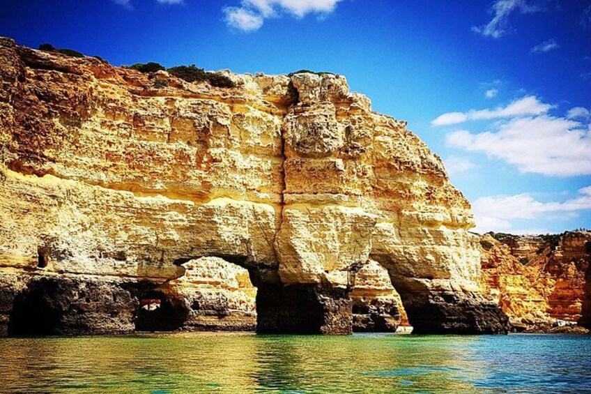 A coastal cliff with a natural arch formation. 4