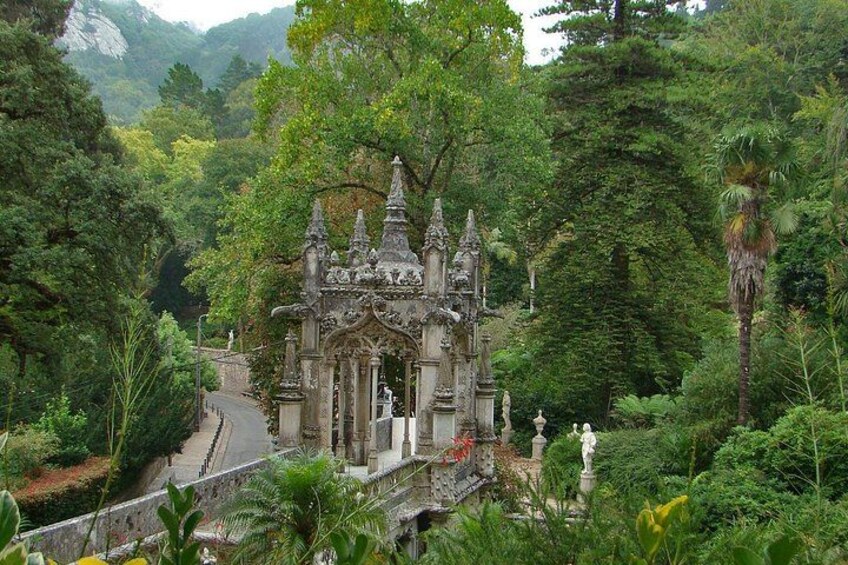 A temple surrounded by lush greenery and a winding path. 4