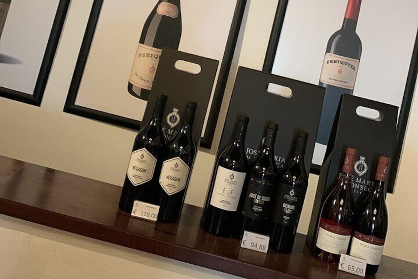 A wine display with bottles labeled 'HELAZON' and 'DOMAINE'. Prices are €118.00, €94.88, and €65.00. 2