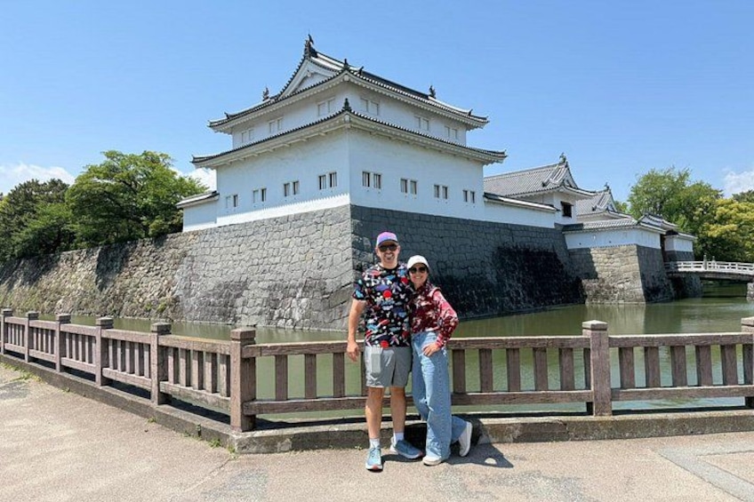 A castle with a stone wall and a wooden bridge. 5