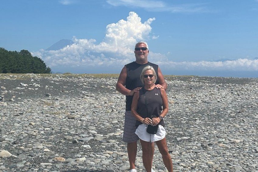 A rocky beach with a mountain in the background. 5