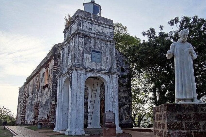 A weathered historical building with a statue in front. 5