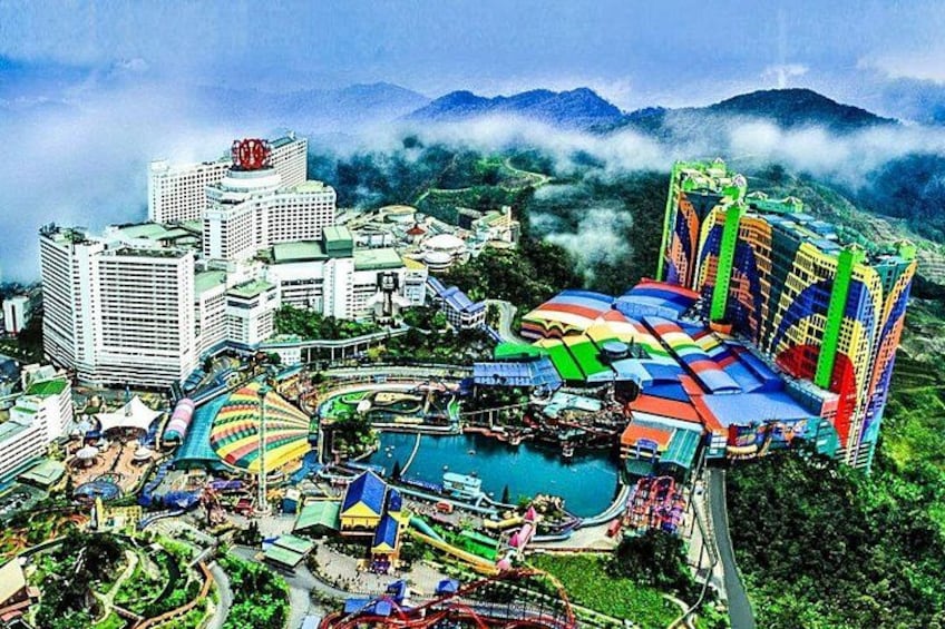 A theme park with colorful buildings, a large pool, and roller coasters. 2