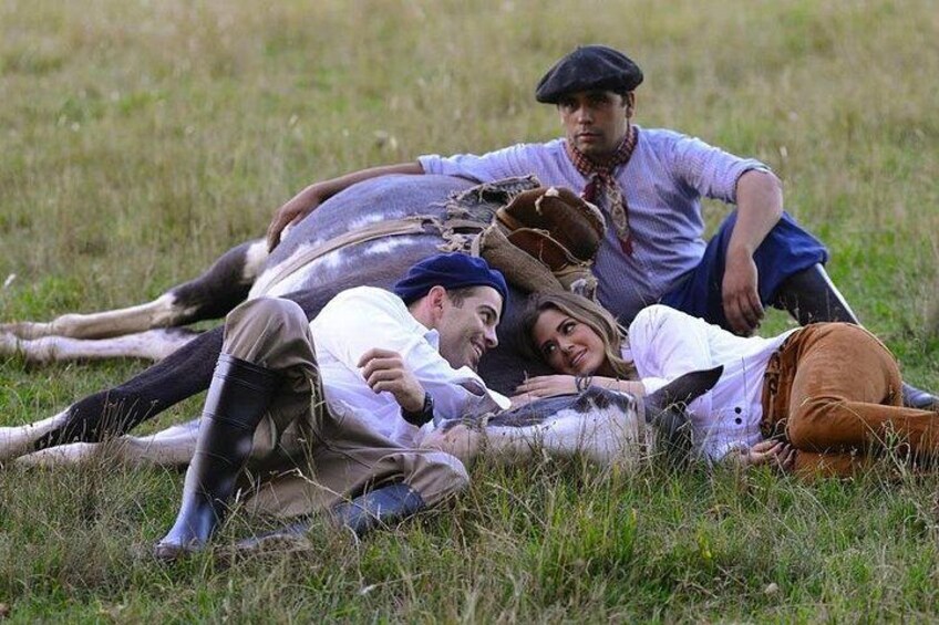 A group of people lying on the ground in a grassy field. 5