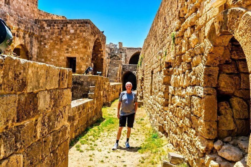 An ancient stone structure with a person standing in the center. 4