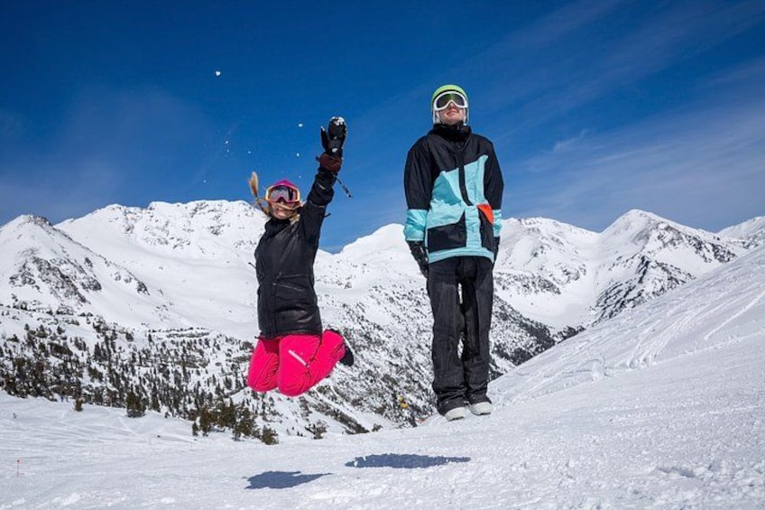 Two people on a snowy mountain with a clear sky. 3
