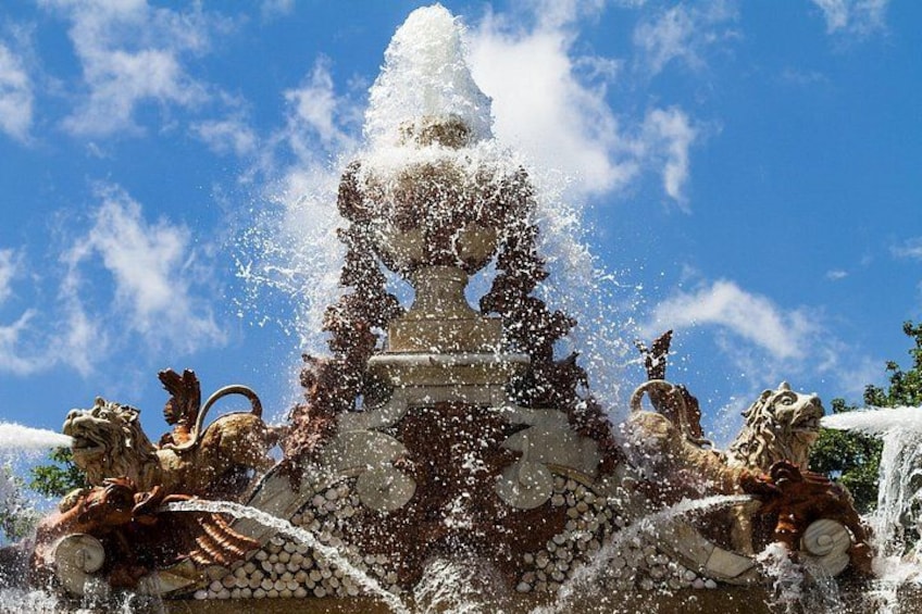 A fountain with water jets and lion statues. 3