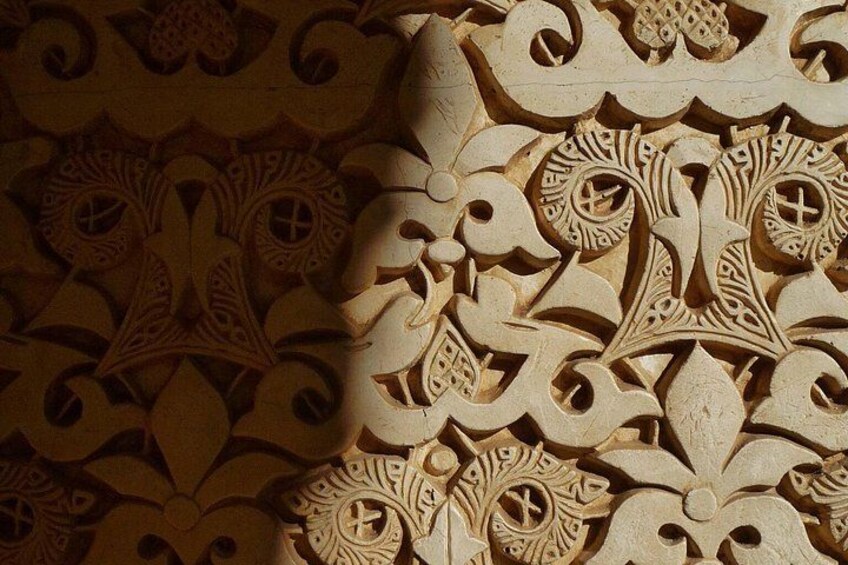 A detailed carved wooden panel with intricate patterns and designs. 3