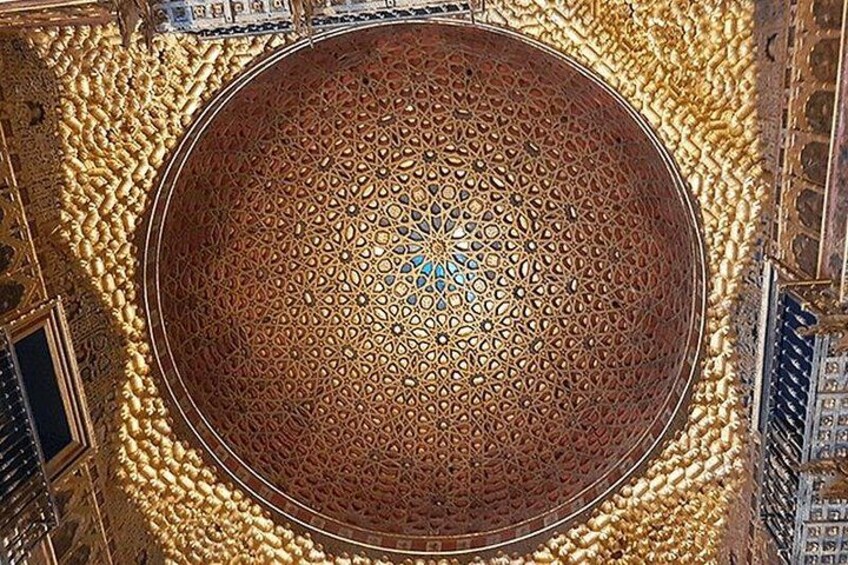 An ornate, circular architectural feature with intricate patterns, surrounded by detailed carvings and a domed ceiling. 2