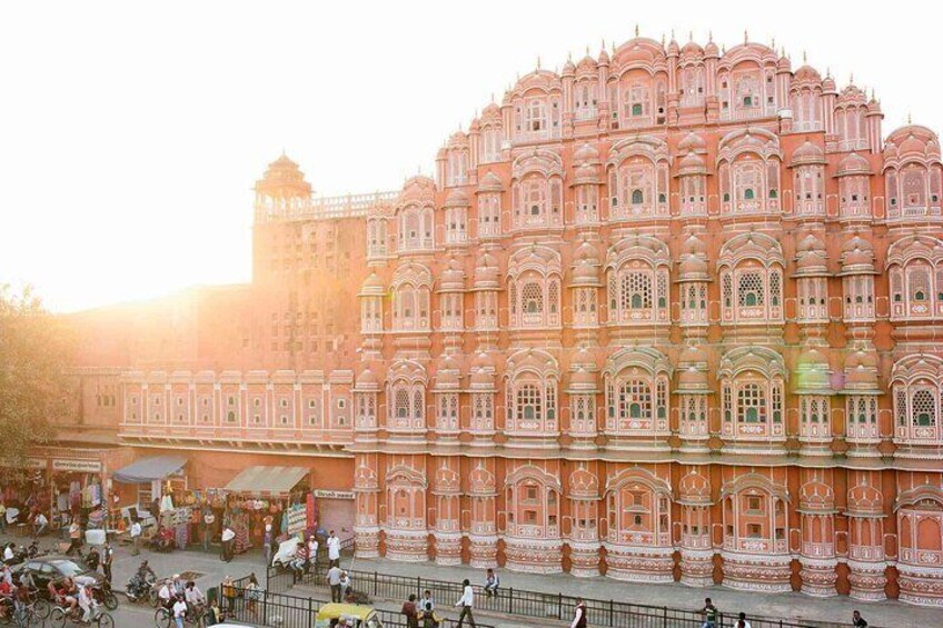 A large, ornate building with intricate architecture and a crowd of people in front. 3
