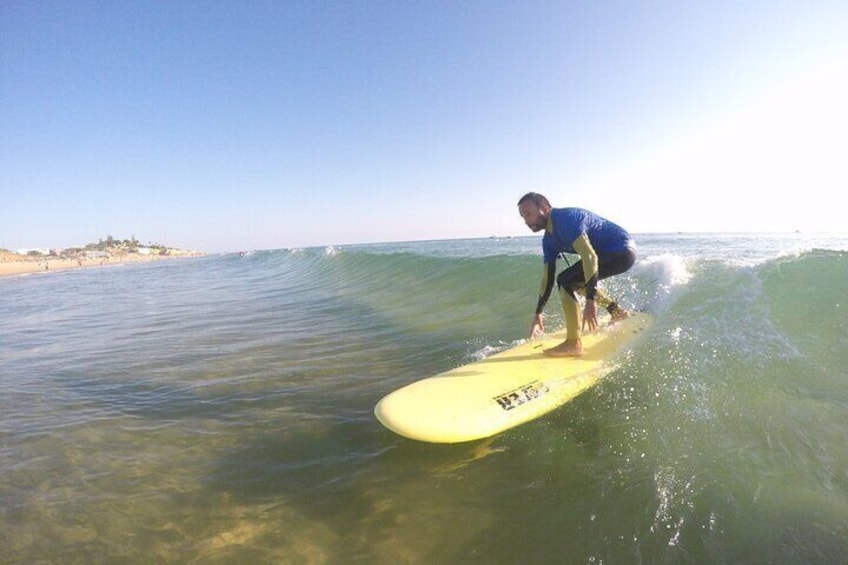 A person surfing on a yellow surfboard in the ocean. 1