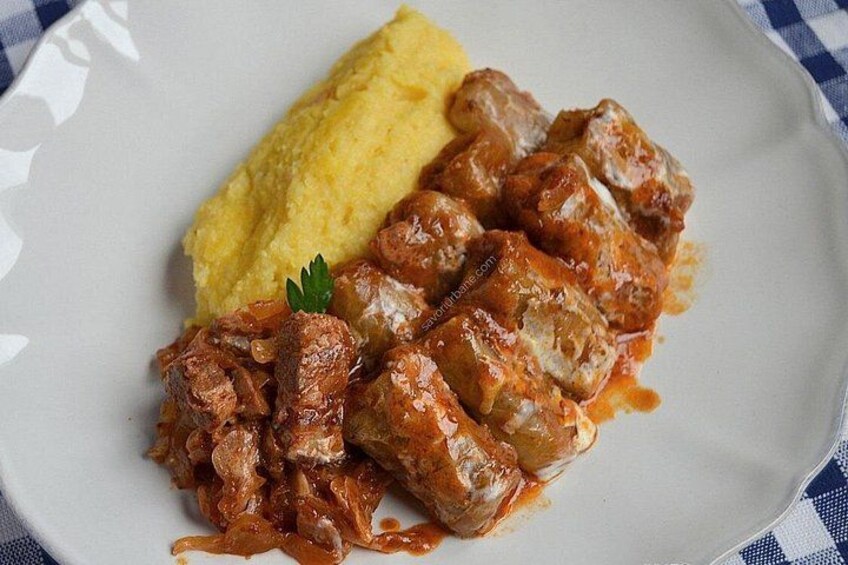 A plate with meat in sauce and mashed potatoes. 2