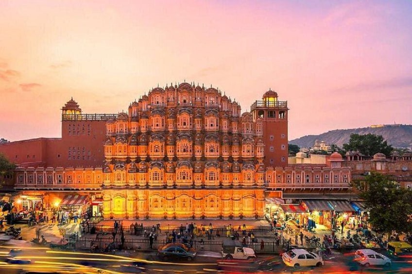 A historic building with intricate architecture, a bustling street in front, and a clear sky. 3