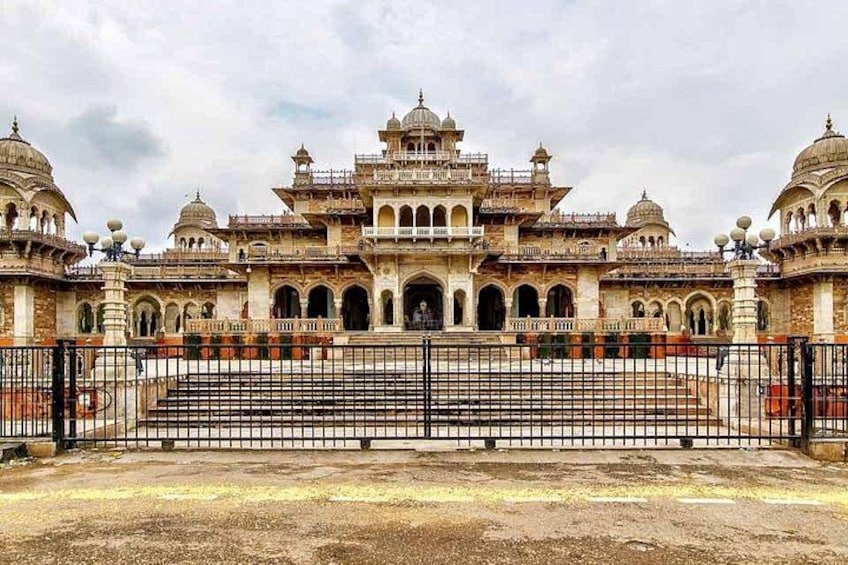 A large, ornate building with multiple domes and arches, surrounded by a fence. 4