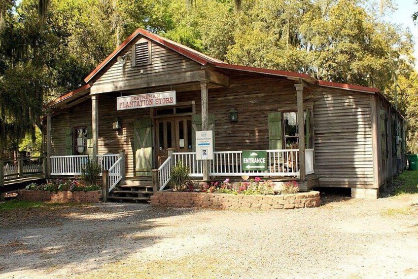 A wooden building with a porch, labeled 'Plantation Store,' surrounded by trees. 5