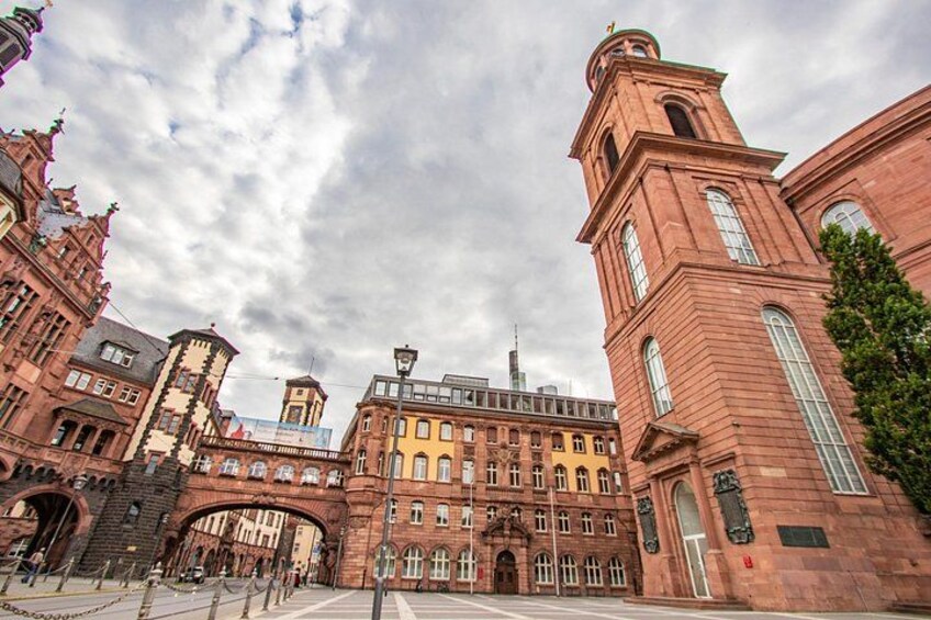 A historic building with a tower, arched bridge, and ornate architecture. 1