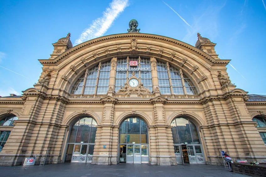 A large, ornate building with a prominent clock tower and arched windows. 3