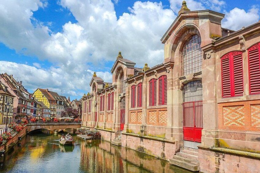 A canal with buildings, a bridge, and a boat. 3