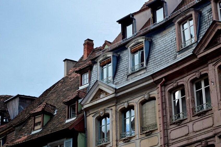 A row of historic buildings with ornate facades and steeply pitched roofs. 5
