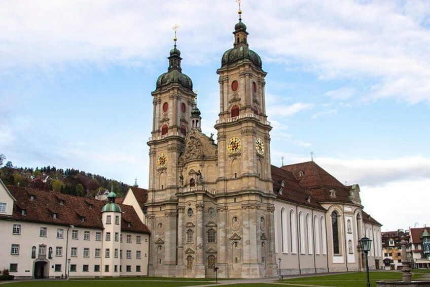 Eine historische Kirche mit zwei Türmen, einer Uhr und einem Glockenturm. 3