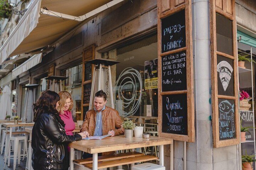 A café with outdoor seating, a chalkboard menu, and a wooden facade. 5