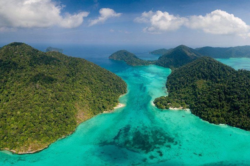 A turquoise sea surrounded by lush green islands. 1