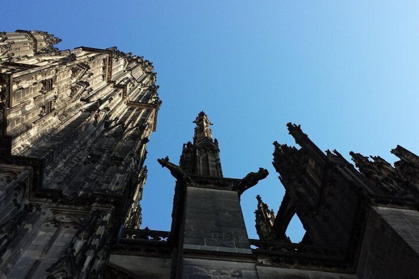 A ruined building with intricate stonework and a statue in the center. 2