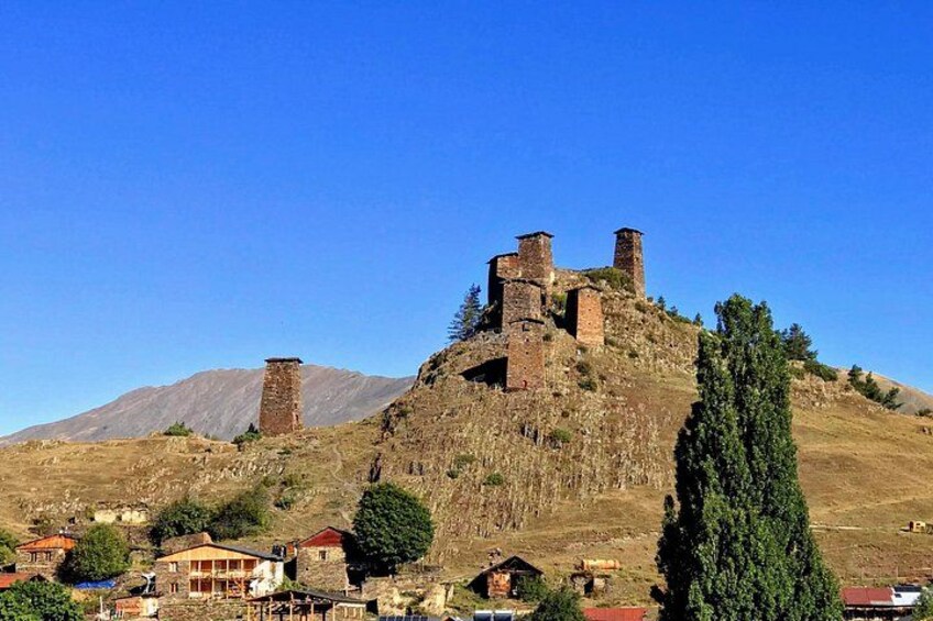 A historic castle on a hill with a clear sky. 3