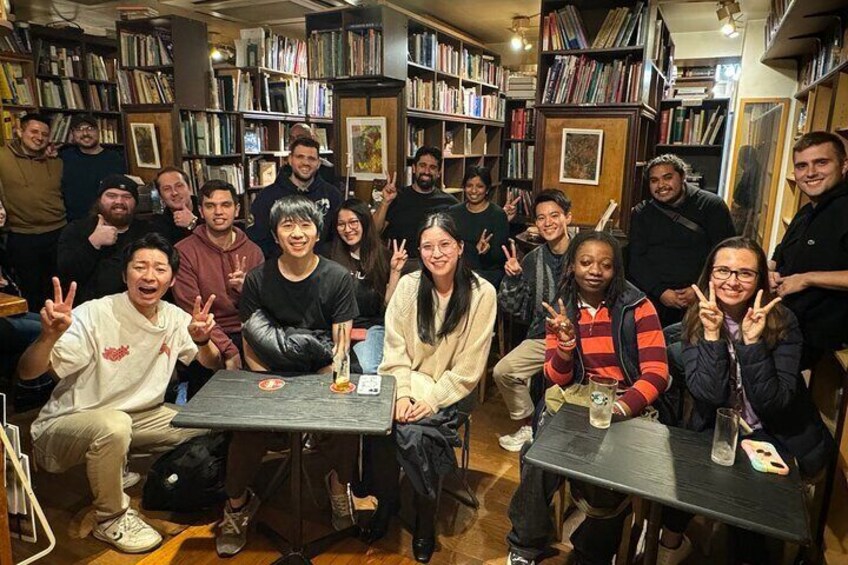 A group of people in a bookstore with bookshelves in the background. 5