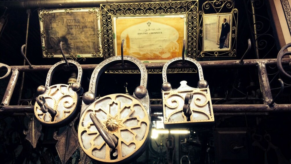 Ornate metal clocks with intricate designs and Arabic calligraphy. 5