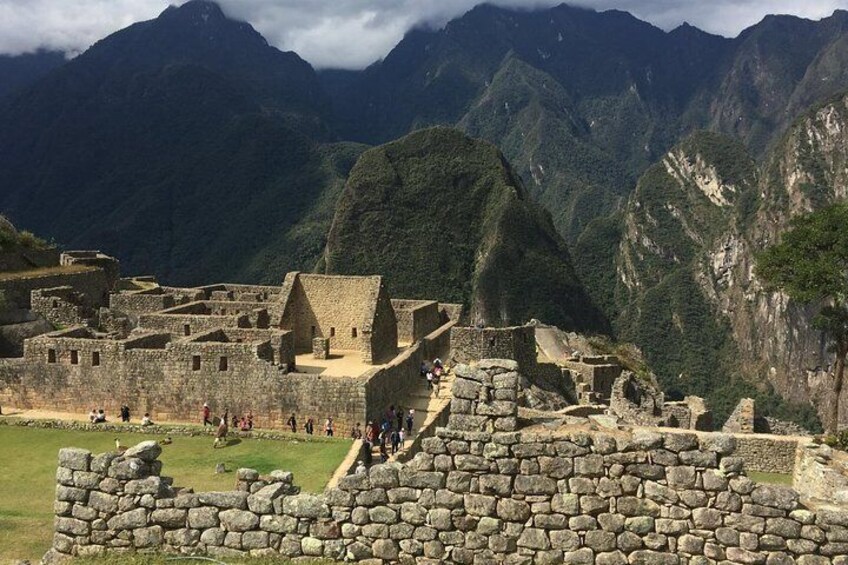 The ruins of Machu Picchu with Inca stone walls and terraces, set against a backdrop of mist-covered mountains. 3