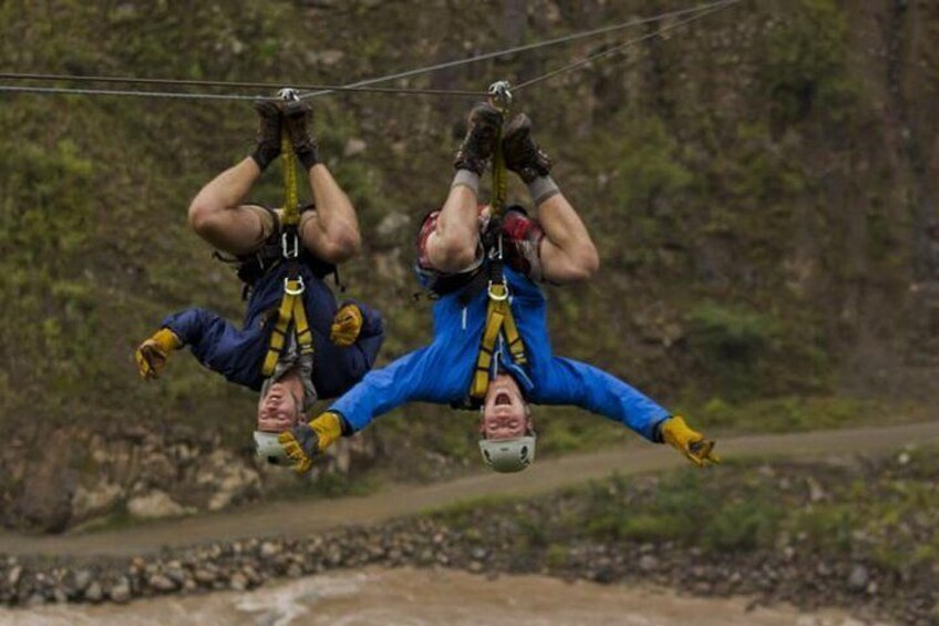 Two people bungee jumping with harnesses and helmets. 5