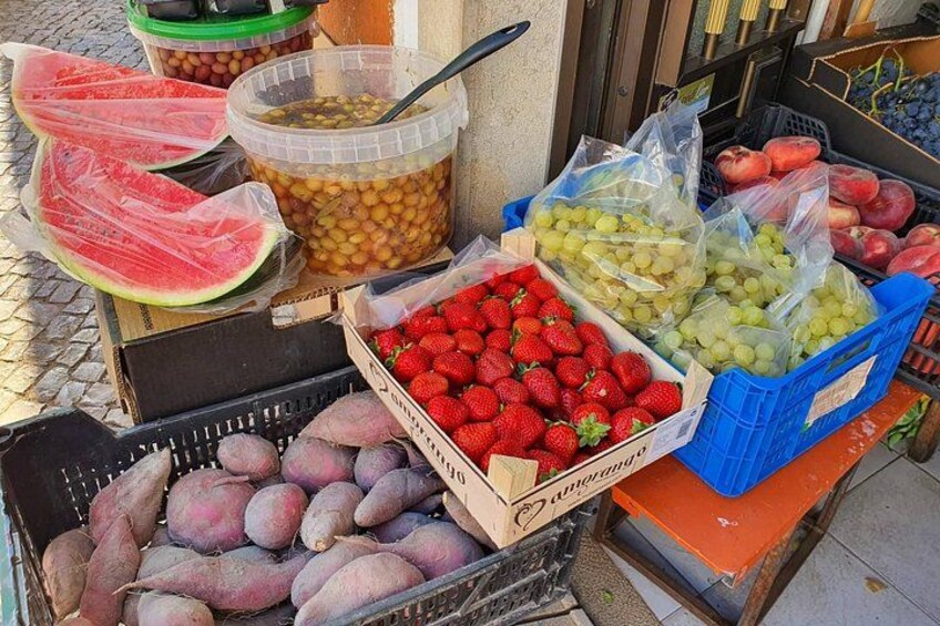 A variety of fresh fruits and vegetables displayed at a market stall. 3