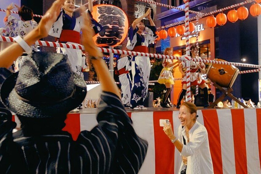 Un evento festivo con artistas, una multitud y un escenario decorado. 5