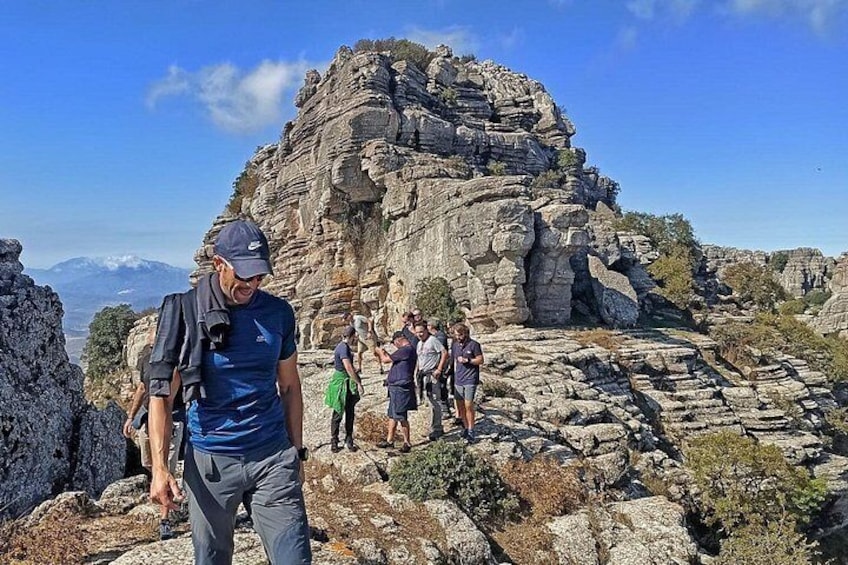 A rocky mountainous landscape with hikers. 2
