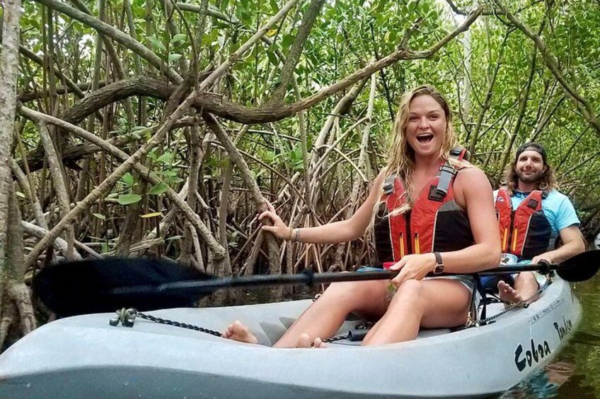 A couple smile as they kayak through the mangrove tunnels in the Thousand Islands Conservation Area. Fin Expeditions Kayak Tours is rated one of the top things to do in Cocoa Beach, Florida! 4