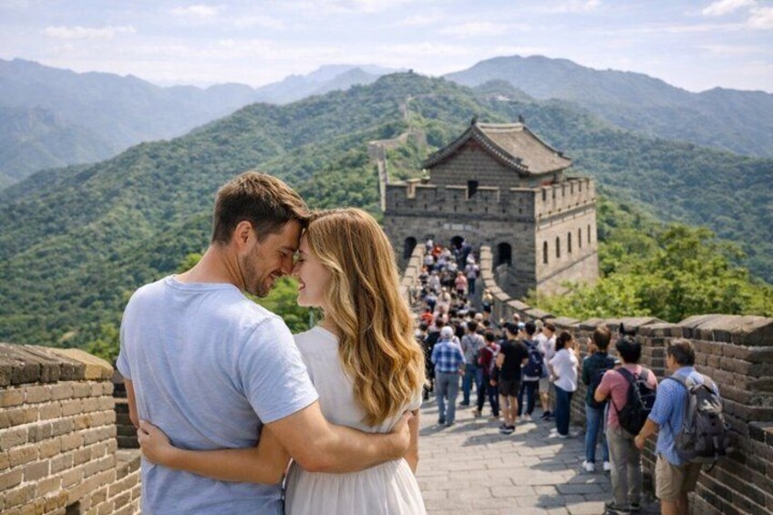 A couple embracing on the Great Wall of China with lush green mountains in the background. 4