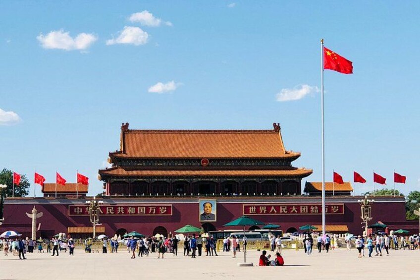 A traditional Chinese building with a red roof and multiple red flags. 1