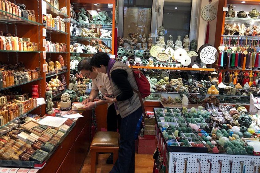 A store with shelves of various items, including ceramics and figurines. 4