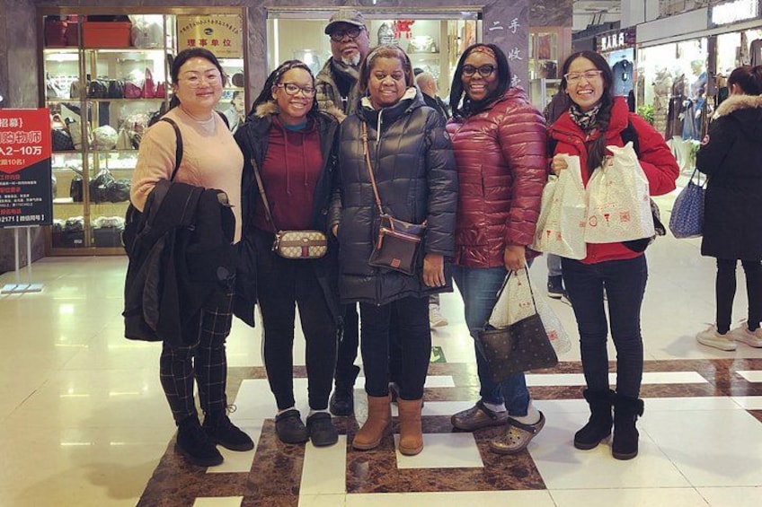 A group of people standing in a shopping mall. 3