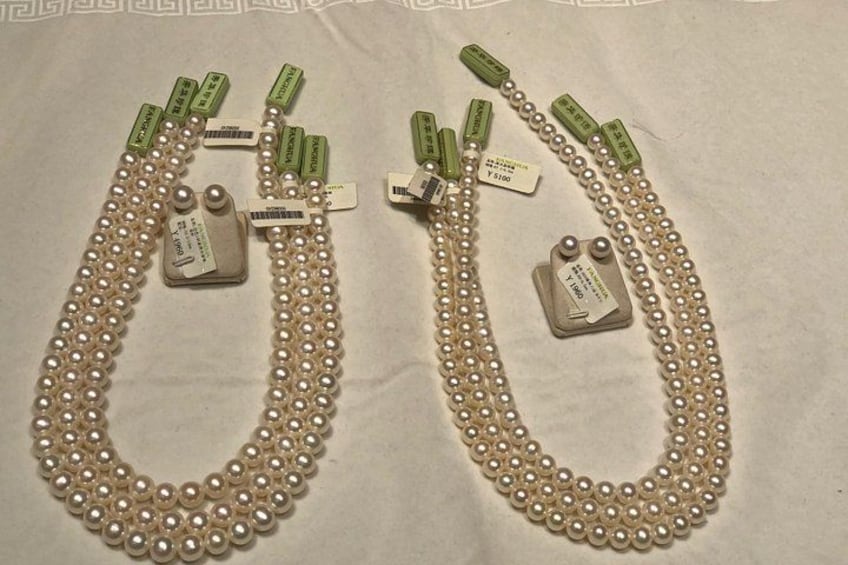 Two pearl necklaces with matching tags. 5