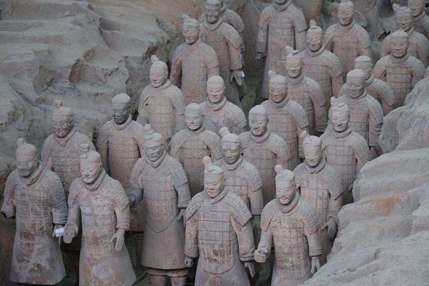 A large group of terracotta soldiers in a formation. 3